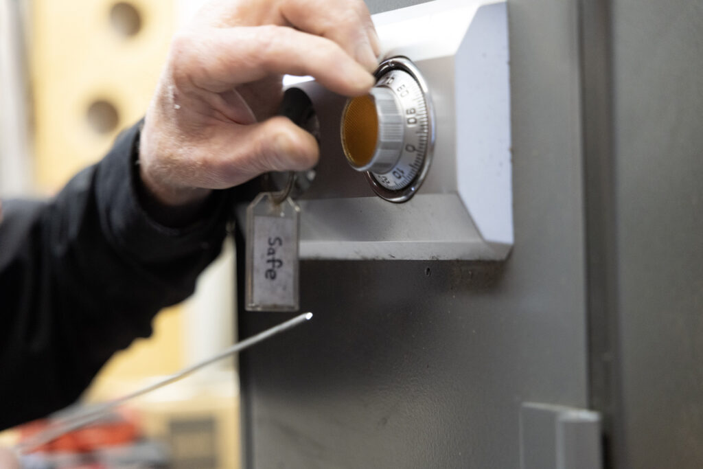 Residential locksmith installing a high-security deadbolt on a front door.